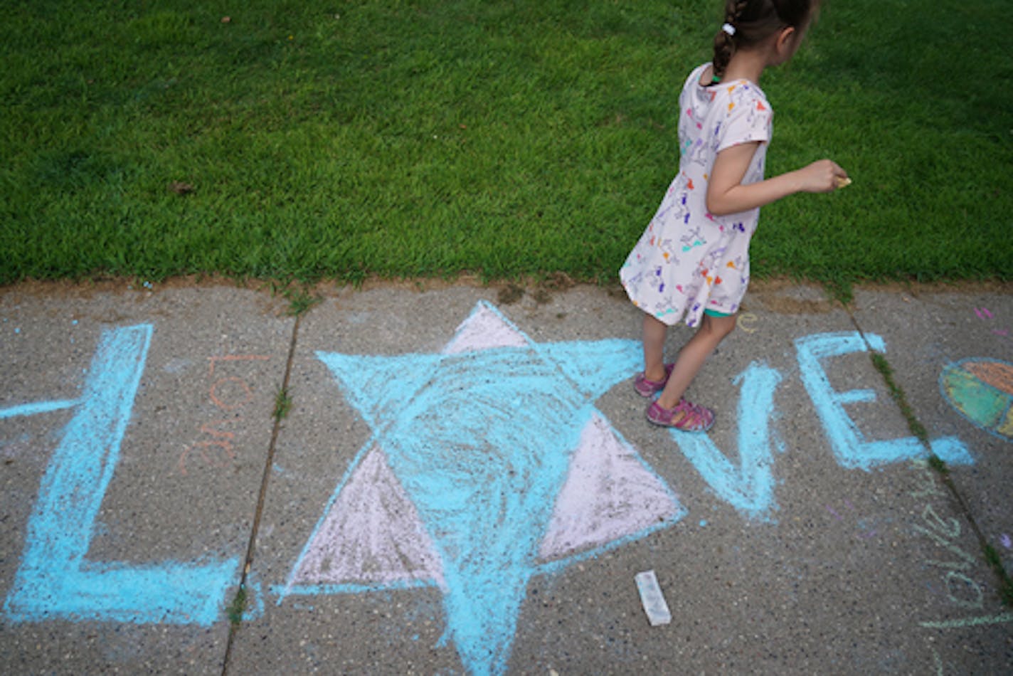 The morning after an anti-Semitic message was left at the Lake Harriet Upper Elementary School in Minneapolis, chalk was available for people to leave positive messages of love and inclusion as a response.