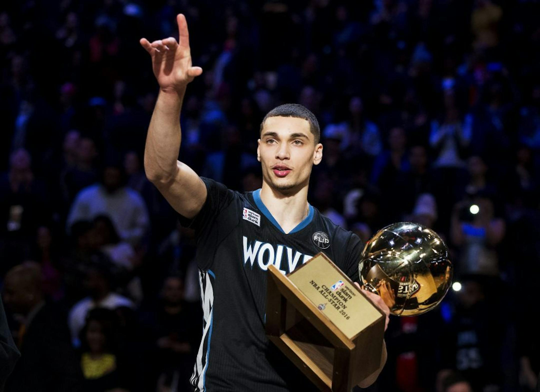 Minnesota Timberwolves' Zach LaVine holds the trophy after winning the slam dunk contest during the NBA All-Star weekend in Toronto, Saturday, Feb. 13, 2016.