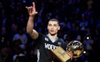 Minnesota Timberwolves' Zach LaVine holds the trophy after winning the slam dunk contest during the NBA All-Star weekend in Toronto, Saturday, Feb. 13