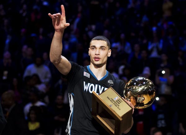 Minnesota Timberwolves' Zach LaVine holds the trophy after winning the slam dunk contest during the NBA All-Star weekend in Toronto, Saturday, Feb. 13