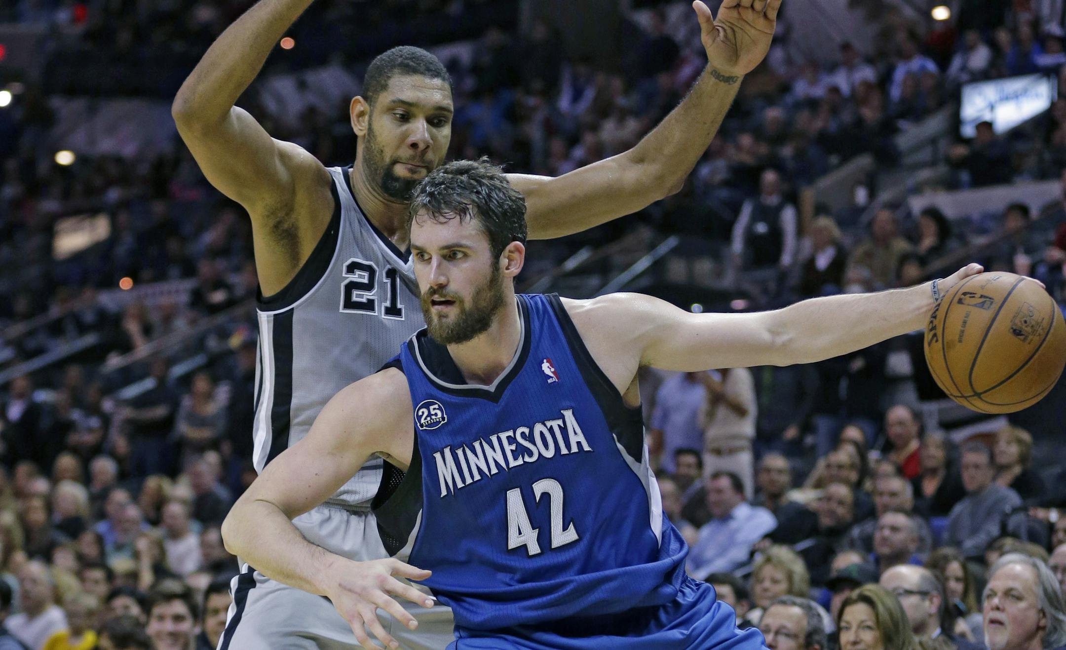 Minnesota Timberwolves' Kevin Love (42) works around San Antonio Spurs' Tim Duncan (21) during the second half on an NBA basketball game, Friday, Dec. 13, 2013, in San Antonio. San Antonio won 117-110. (AP Photo/Eric Gay)