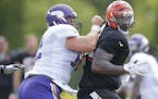 Bengals defensive tackle DeShawn Williams, right, tried to spin past Vikings center Nick Easton during their teams' joint practice last week.
