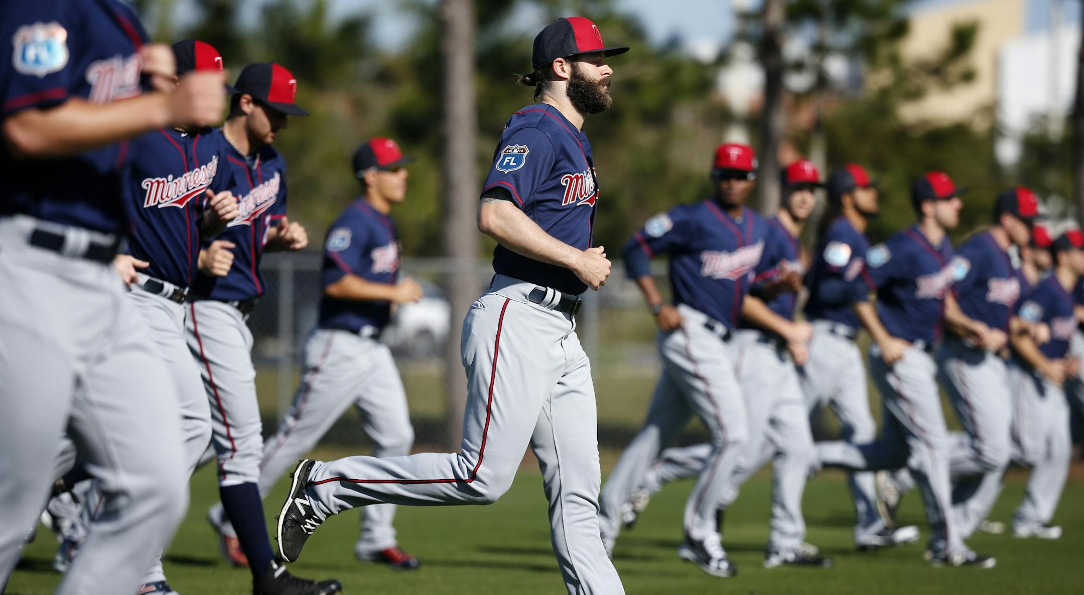 Minnesota Twins pitchers jogged at the beginning of practice. Monday was the first organized practice of spring training for pitchers and catchers.