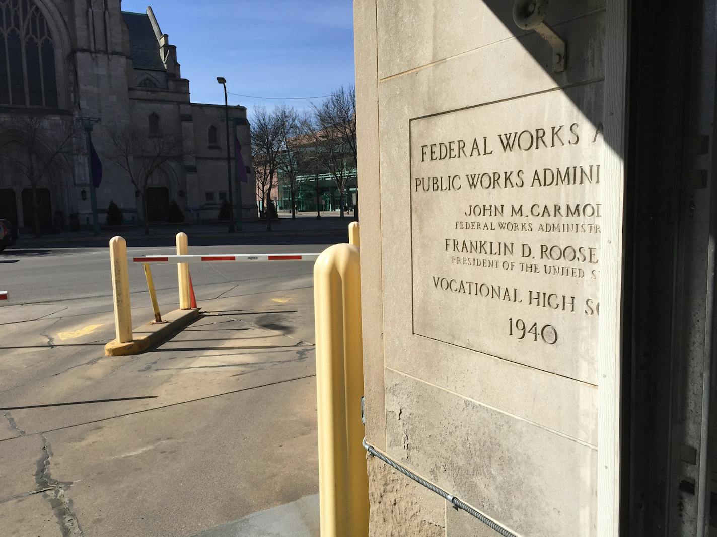 A 1940 marker from Miller Vocational High School was cut in half to build a parking ramp at what is now Century Plaza. Hennepin County is selling the 1930s building and it could be demolished by a buyer.