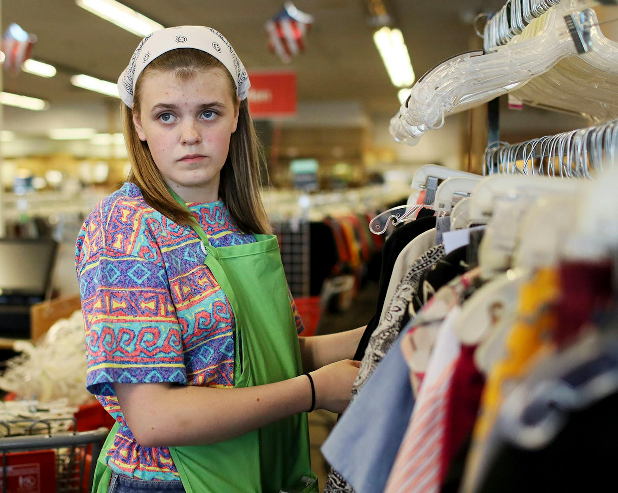 Lacey Athey, 18, landed a job in April at Unique Thrift Store in Columbia Heights, where she sorted through racks of recycled clothing Thursday, May 31, 2018, at work in Columbia Heights, MN.