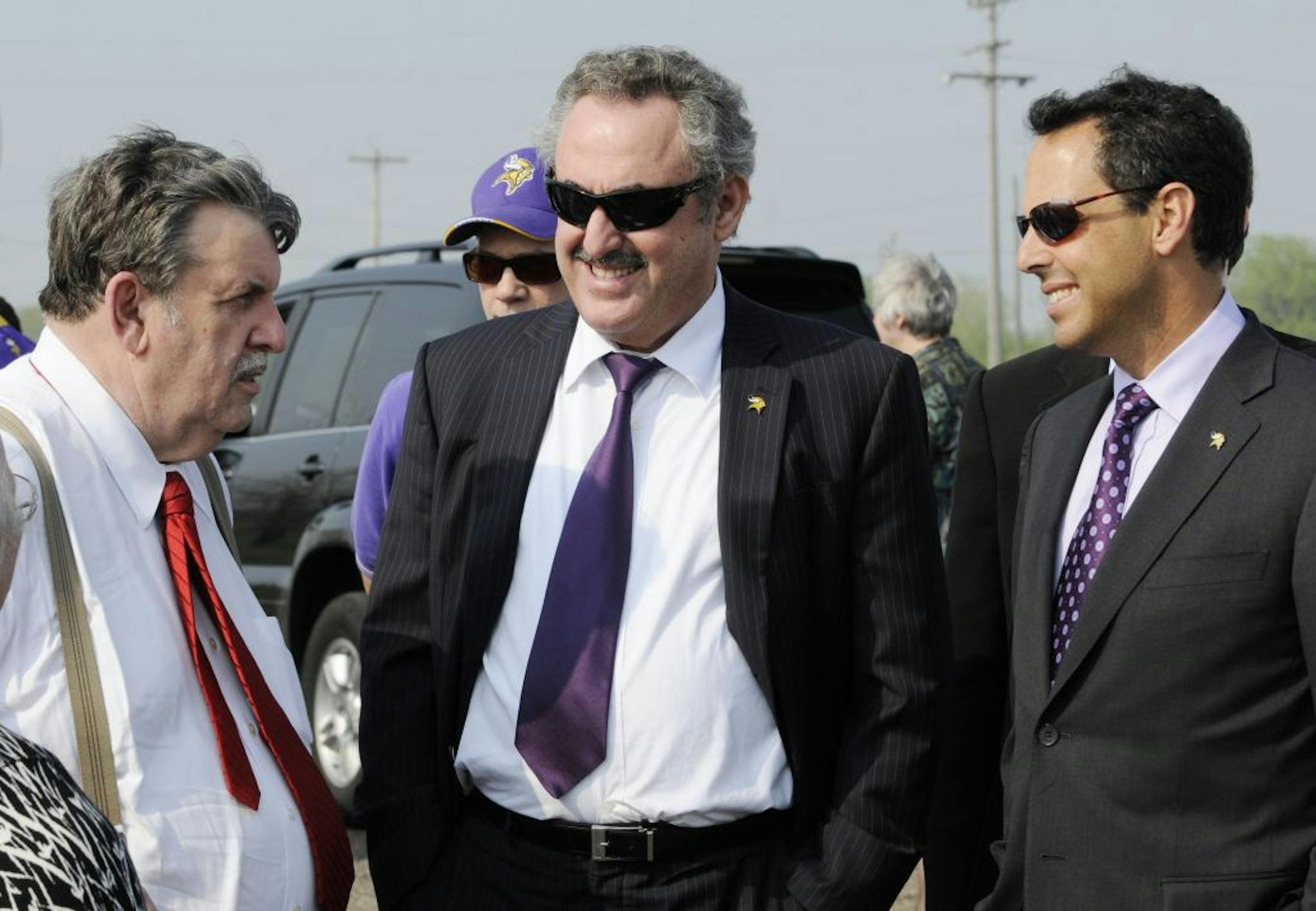 Minnesota Vikings team owners Zygi, center, and Mark Wilf, right, visit with Ramsey county commissioner Tony Bennett Tuesday, May 10, 2011 in Arden Hills, Minn.,at the site of a proposed $1.1 billion retractable-roof football stadium on the grounds of the old Army ammunitions plant in Arden Hills.