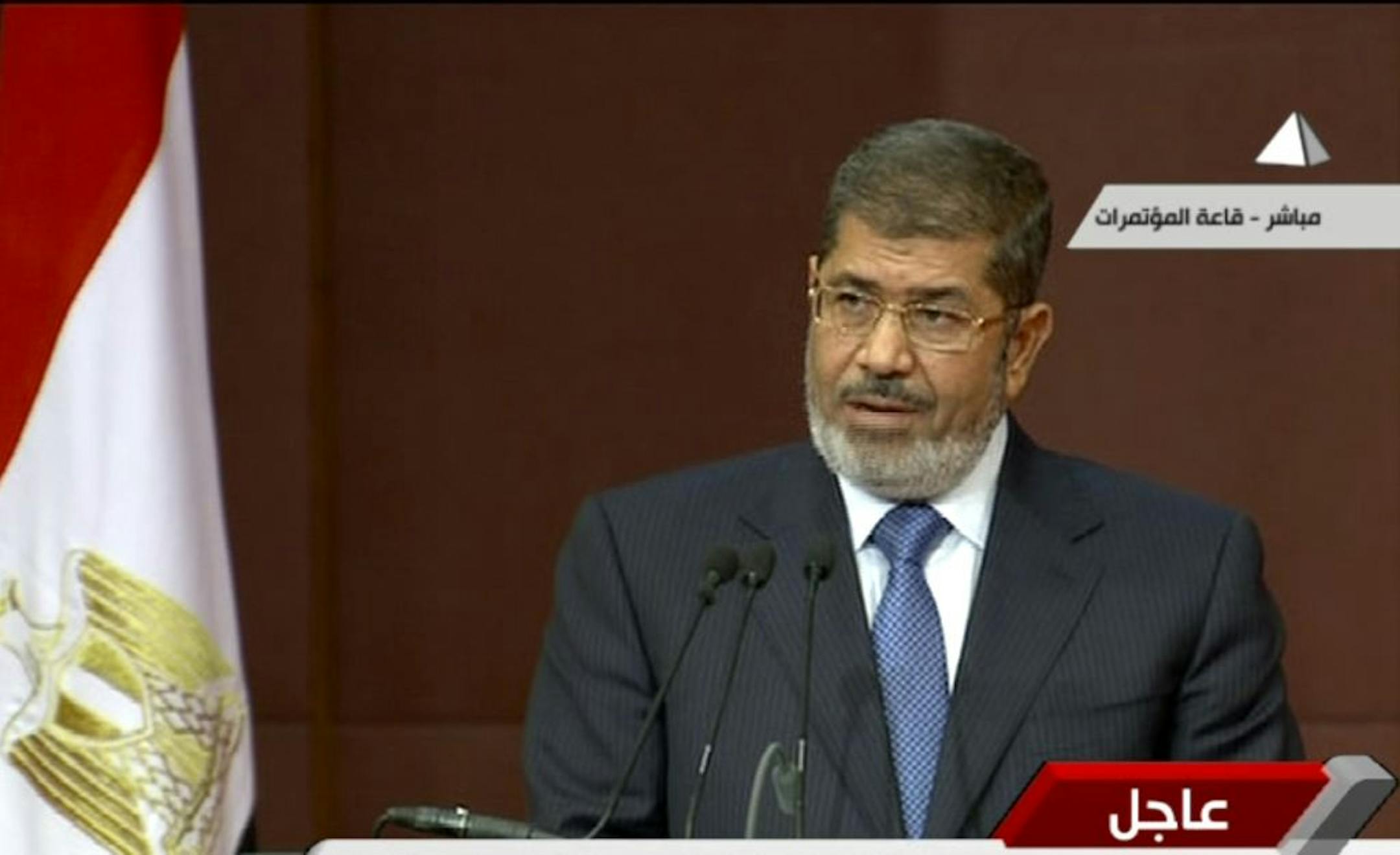 In this image made from a live broadcast on Egyptian State Television, Egyptian President Mohammed Morsi speaks to the constituent assembly in Cairo, Egypt, Saturday, Dec. 1, 2012. Morsi spoke as more than 100,000 Islamists waved Egyptian flags and hoisted portraits of Morsi in rallies nationwide Saturday to support his efforts to rush through a new draft constitution despite widespread opposition by secular activists and some in the judiciary.