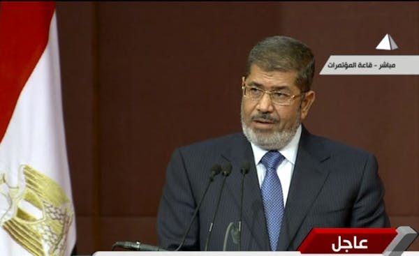 In this image made from a live broadcast on Egyptian State Television, Egyptian President Mohammed Morsi speaks to the constituent assembly in Cairo, 