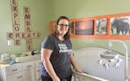 Jen Baumgarten, 38, of St. Louis Park poses in a nursery for the foster care children she's helping. She applied to be a Hennepin County foster care p