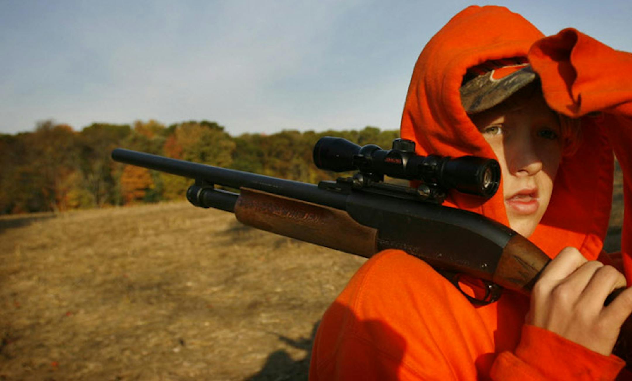 Drew Erickson, 11, gazed into the woods while hunting deer on Saturday with his father, Dennis, near Wyoming, Minn.