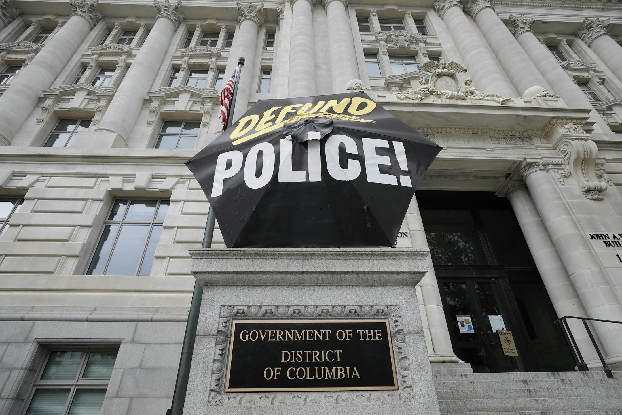 Protesters placed a large umbrella calling to defund the police in from of the major office during a rally to mark Juneteenth which commemorates the end of slavery in Texas, in Washington, D.C., on June 19, 2020. (Yuri Gripas/Abaca Press/TNS) ORG XMIT: 1694961