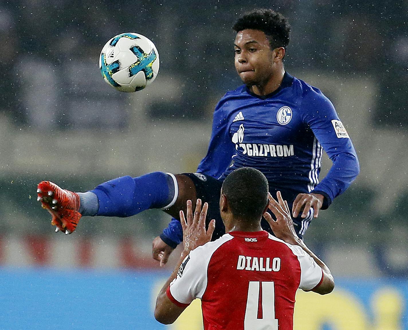 FILE - In this Friday, March 9, 2018 file photo, Mainz's Abdou Diallo, bottom, and Schalke's Weston McKennie challenge for the ball during a German first division Bundesliga soccer match between FSV Mainz 05 and FC Schalke 04 in Mainz, Germany. Weston McKennie at age 19 put himself in position to play for the U.S. at this year's World Cup, only for the Americans to miss soccer's showcase for the first time since 1986. (AP Photo/Michael Probst, File)