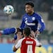 FILE - In this Friday, March 9, 2018 file photo, Mainz's Abdou Diallo, bottom, and Schalke's Weston McKennie challenge for the ball during a German fi