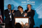 Thomas Perez, the former labor secretary, hugged Rep. Keith Ellison of Minnesota at the Democratic National Committee's winter meeting in Atlanta on S