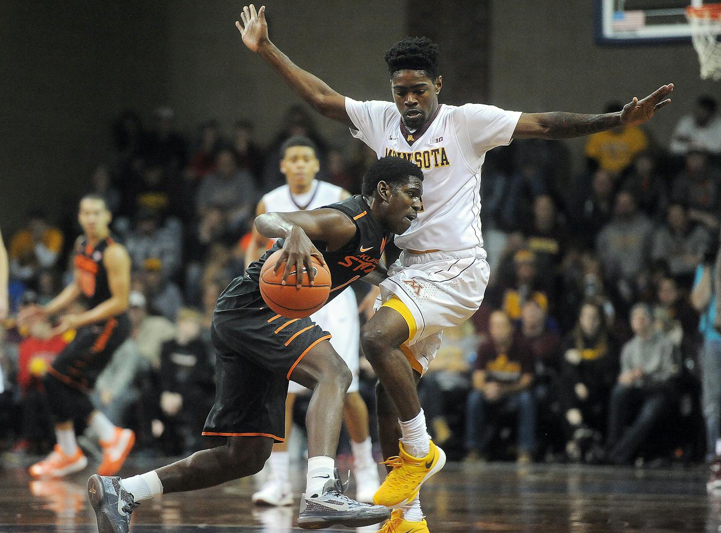 Oklahoma State's Jawun Evans dribbles the ball up the court while Minnesota's Kevin Dorsey guards at the Sanford Pentagon in Sioux Falls on Saturday, Dec. 12, 2015. (Jay Pickthorn/The Argus Leader via AP)