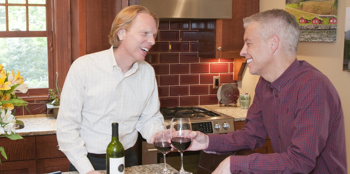 Michael D. Braun Lee Anderson and William Fehrenbach in kitchen of their bungalow featured on Edina Historic Home Tour.