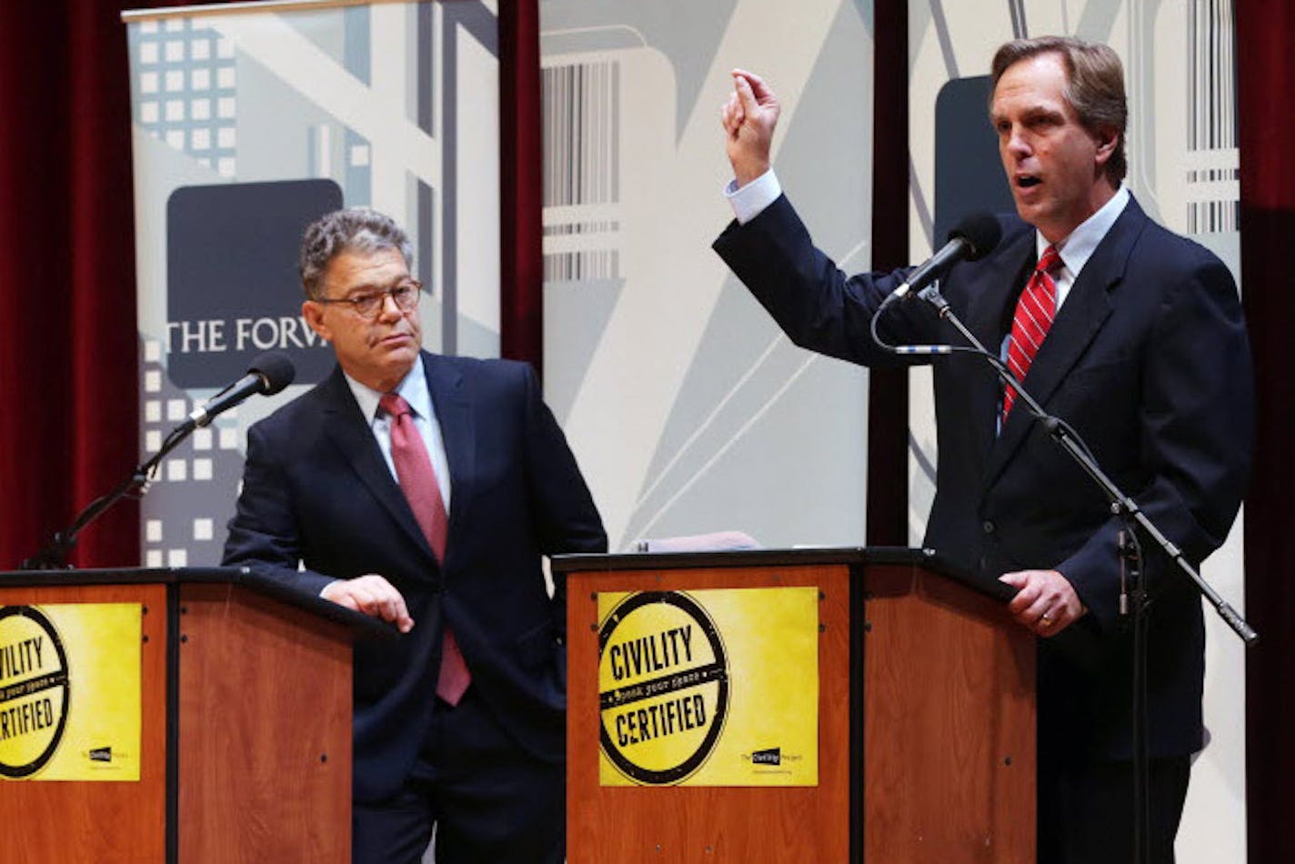 Democratic U.S. Sen. Al Franken, left, listens as his Republican challenger Mike McFadden gives his closing statement during their debate, Wednesday, Oct. 1, 2014, in Duluth, Minn.