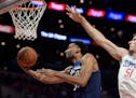 Minnesota Timberwolves forward Keita Bates-Diop, left, shoots as Los Angeles Clippers center Boban Marjanovic defends during the second half of an NBA