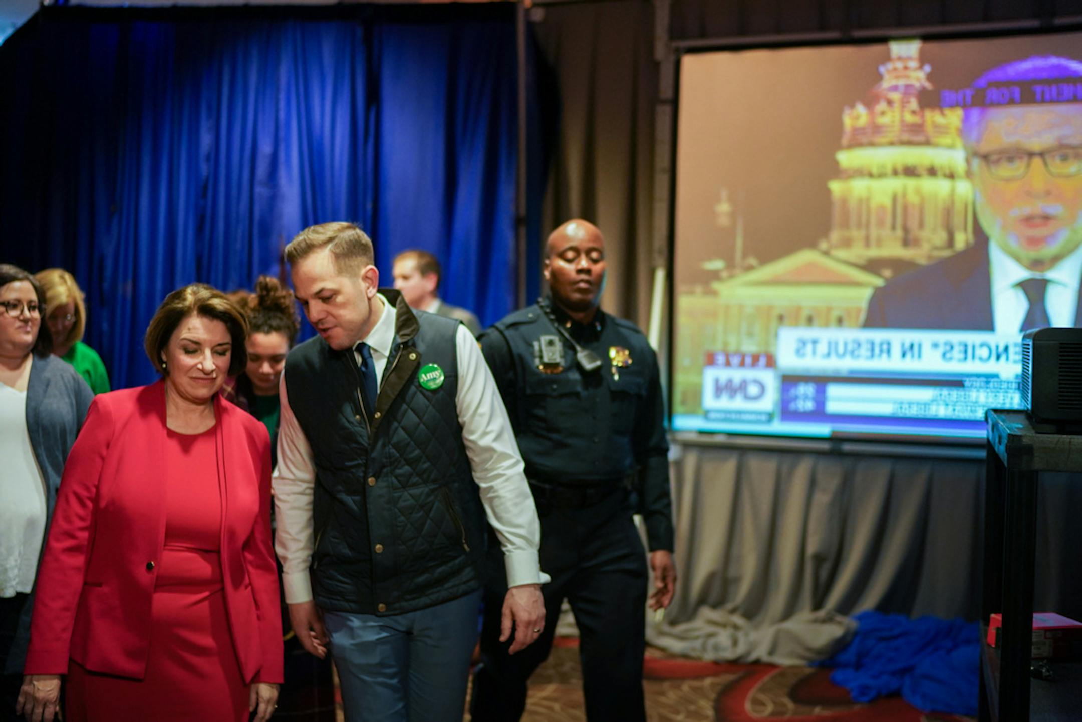 With campaign manager Justin Buoen at her side, Amy Klobuchar walked backstage to greet almost 100 staffers gathered in the war room at he Des Moines Marriott on Feb. 3.