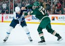 Minnesota Wild left wing Marcus Foligno (17) fights Winnipeg Jets defenseman Brenden Dillon (5) in the first period of their game Tuesday, Oct. 19, 20