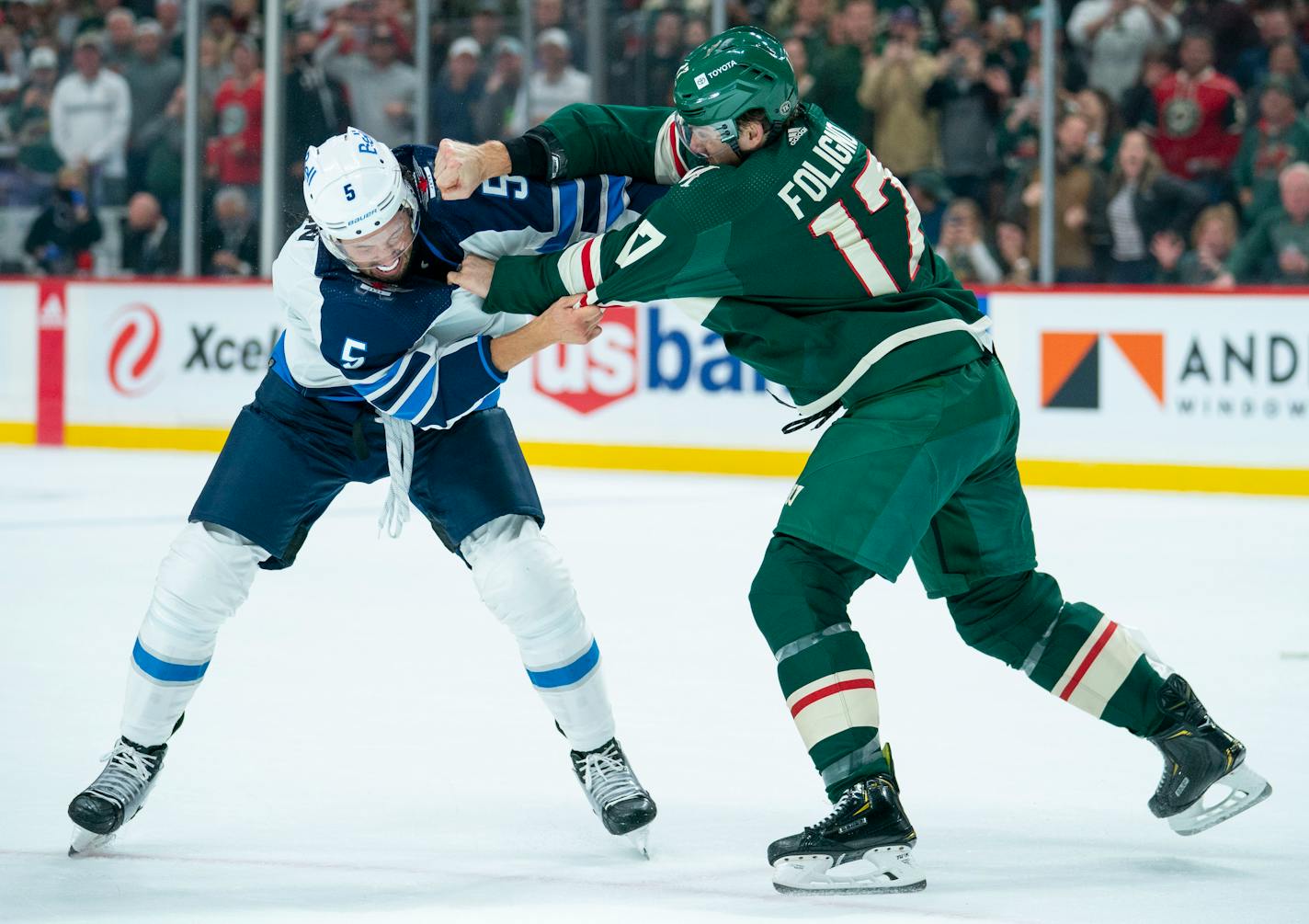 Minnesota Wild left wing Marcus Foligno (17) fights Winnipeg Jets defenseman Brenden Dillon (5) in the first period of their game Tuesday, Oct. 19, 2021at Xcel Energy Center in St. Paul, Minn. The two teams had players getting into small scraps throughout the period before this fight. ]