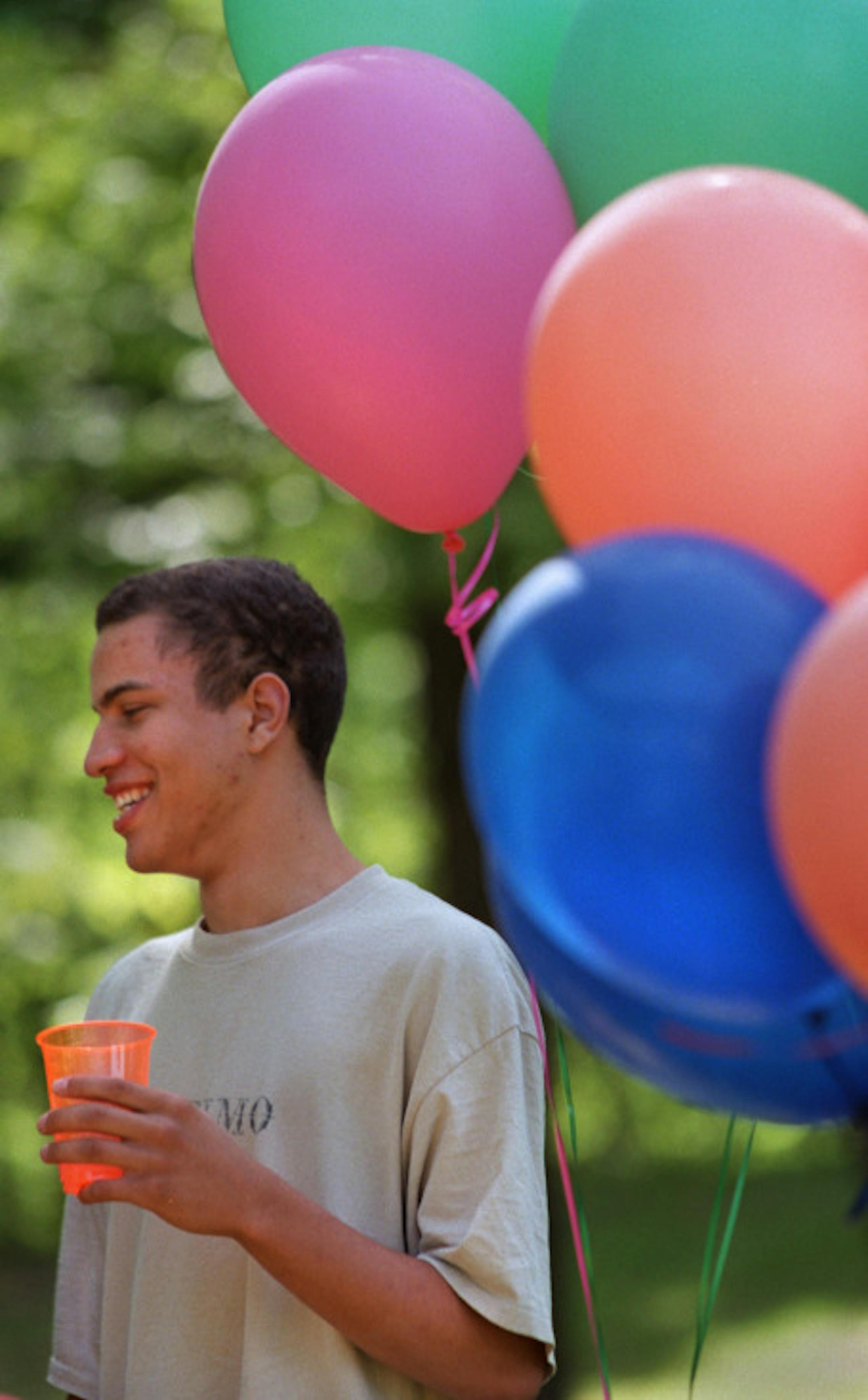 James Archer enjoyed the punch drink.  Taste story on graduation party menu. will be using real graduates at picnic site near their school. menu includes grilled pizza...want pix to have look that food magazines have of parties in progress and photog just happens to be there - some of kids eating, some of food itself on picnic table.