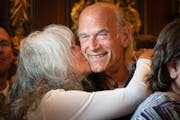 Former Minnesota Gov. Jesse Ventura got a big kiss and hug from his wife, Terry, in 2023 after the cannabis bill was signed into law.