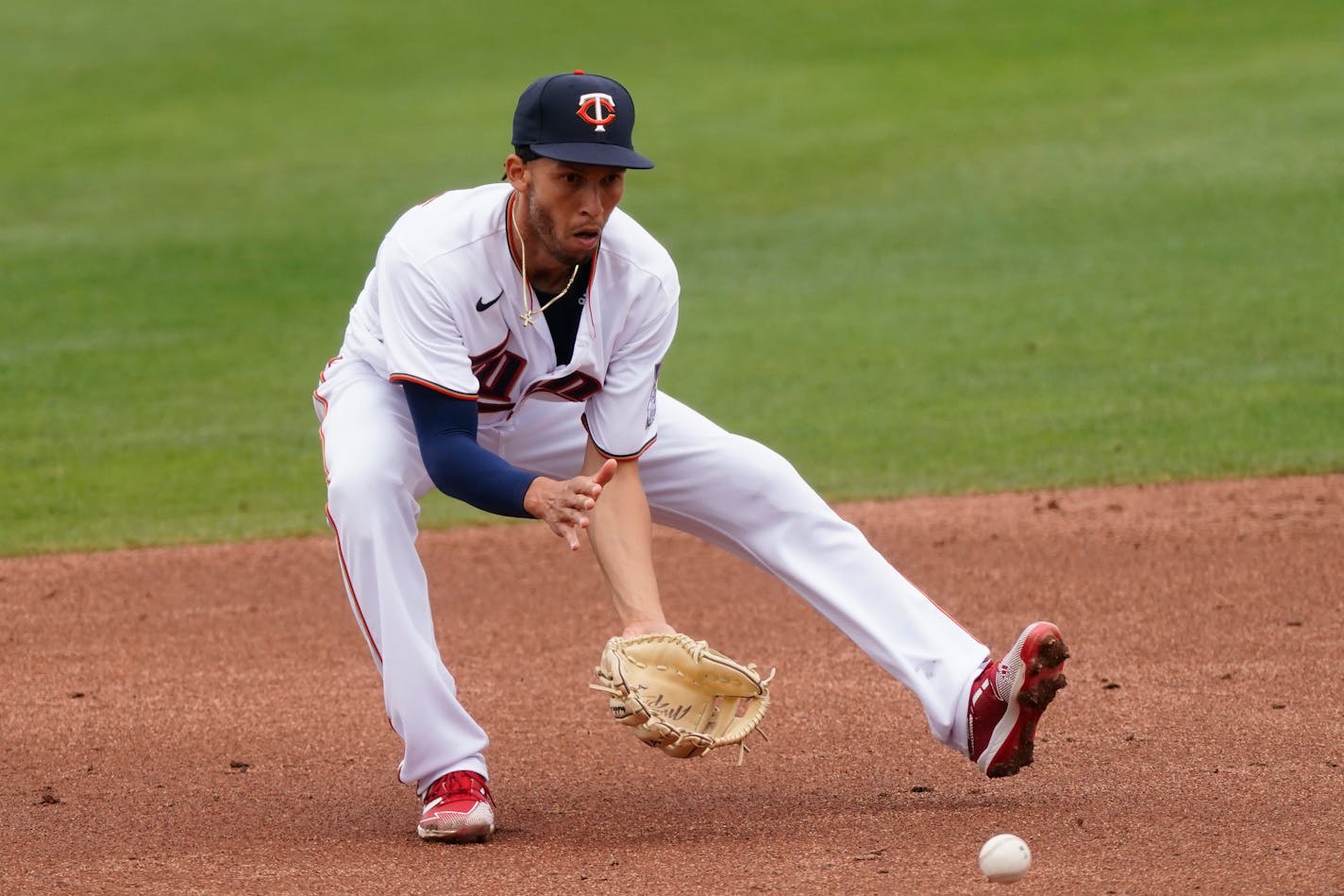 Minnesota Twins shortstop Andrelton Simmons (9) fields a ground ball from Atlanta Braves' Austin Riley in the third inning of a spring training baseball game Monday, March 22, 2021, in Fort Myers, Fla. (AP Photo/John Bazemore)