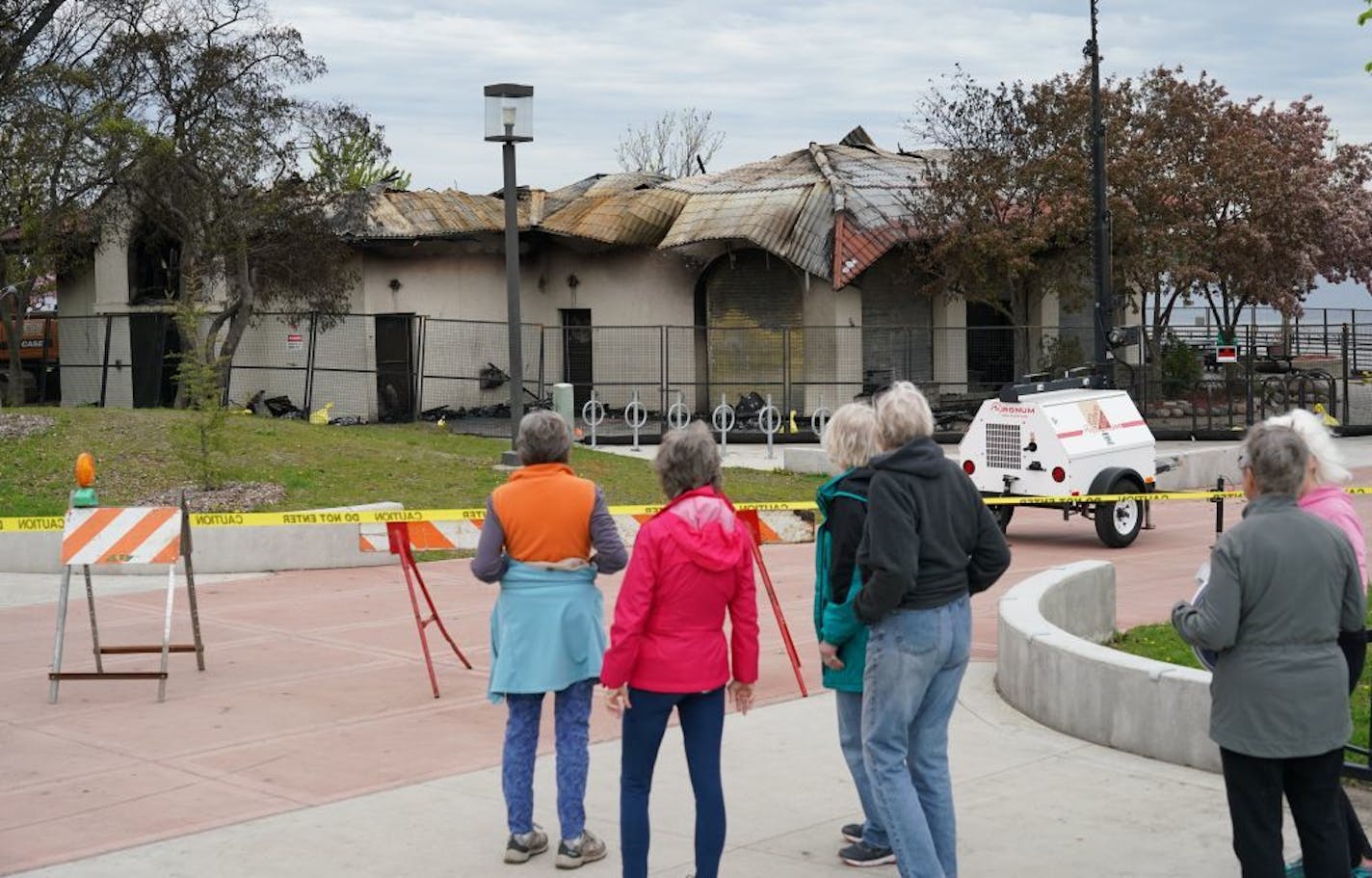 A day and a half after fire gutted the lakeside pavilion that housed Lola on the Lake, people still stopped to look at the destruction as inspectors continue to decide if the structure can be restored or if it will have to be demolished. Photographed Friday, May 17, 2019 at Lake Calhoun/Bde Mka Ska in Minneapolis, Minn.