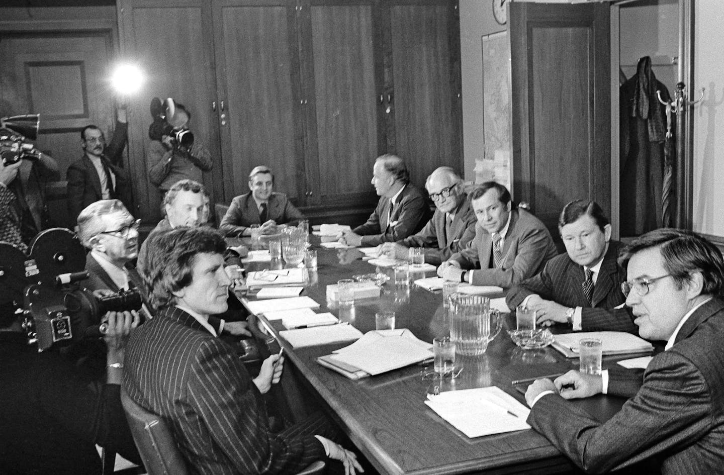 Members of the special Senate Committee created to investigate the CIA, FBI and other U.S. Intelligence gathering agencies meet in Washington, D.C., Feb. 6, 1975. Clockwise around the table starting at lower left are: Sen. Gary Hart (D-Colorado), unidentified stenographer, Richard Schweiker (R-Pa.), Robert Morgan (D-N.C.), partly hidden, Walter Mondale (D. Minn.), Charles McC Mathias (R-Md.), Barry Goldwater (R-Ariz.), Hoiward Baker (R-Tenn.), John Tower (R-Texas), and Frank Church (D-Idaho), ch