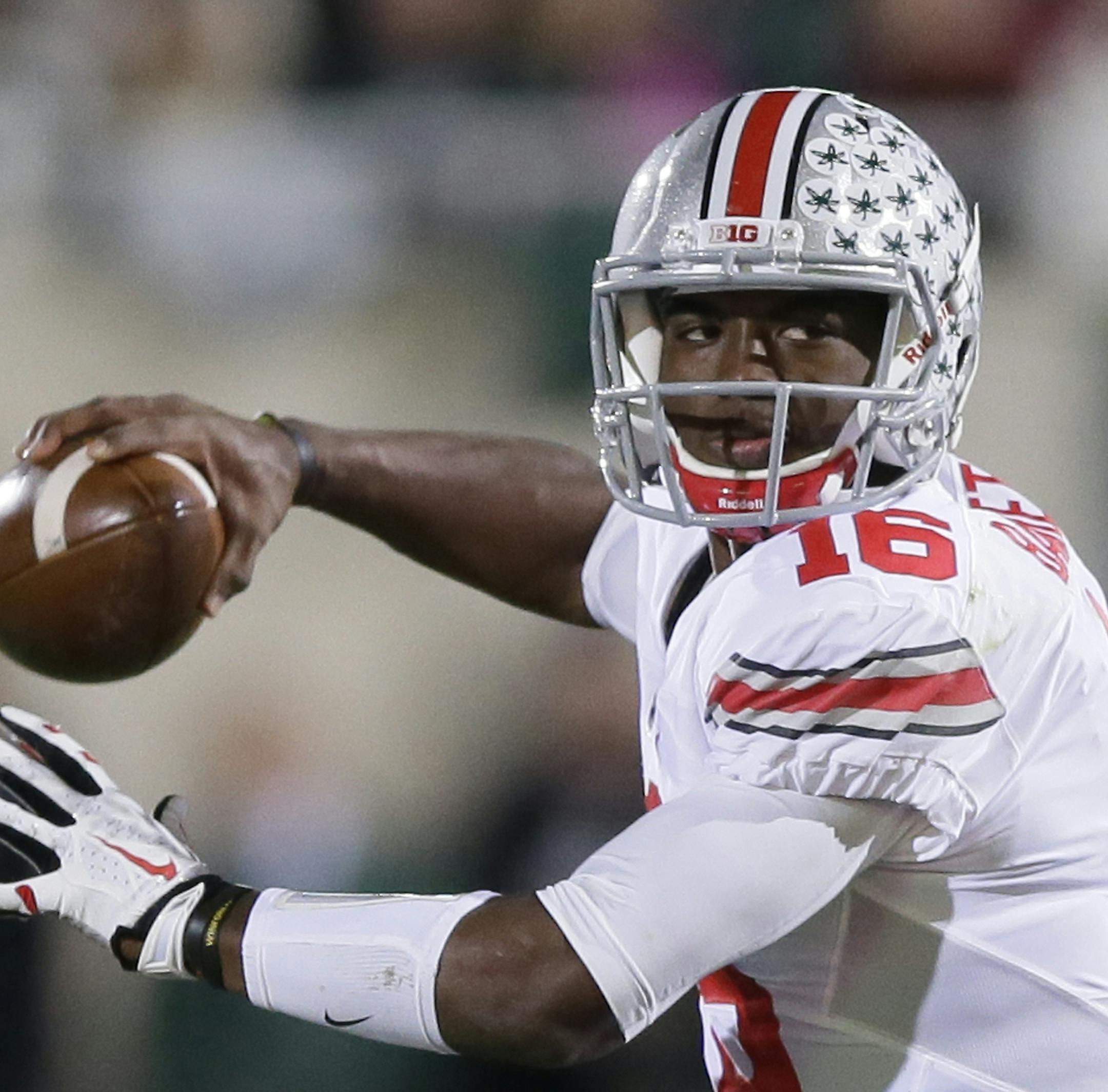 FILE - This Nov. 8, 2014, file photo shows Ohio State quarterback J.T. Barrett looking to pass during the first half of an NCAA college football game against Michigan State in East Lansing, Mich. It’s hard to imagine how far Ohio State’s offense has come so fast. Barrett leads a lethal offense that is averaging 46 points and 512 yards a game. (AP Photo/Carlos Osorio, File)