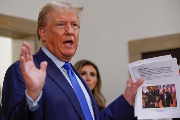 Former President Donald Trump displayed an article outside the courtroom at the New York State Supreme Court on the first day of his civil fraud trial