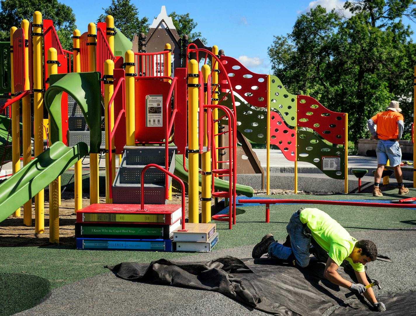 Workers from Morcon Construction put the finishing touches on the new playground at Rev. Dr. Martin Luther King Jr. Park that combines civil rights lessons with play. ] GLEN STUBBE * gstubbe@startribune.com Thursday, August 20, 2015