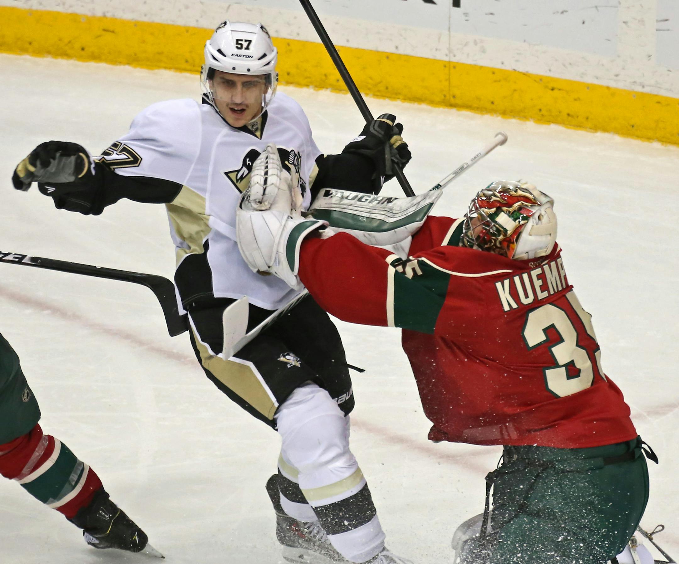 Pittsburgh Penguins' Marcel Goc, left, of Germany, and Minnesota Wild goalie Darcy Kuemper crash together during the first period of an NHL hockey game, Tuesday, Nov. 4, 2014, in St. Paul, Minn. (AP Photo/Bruce Bisping)
