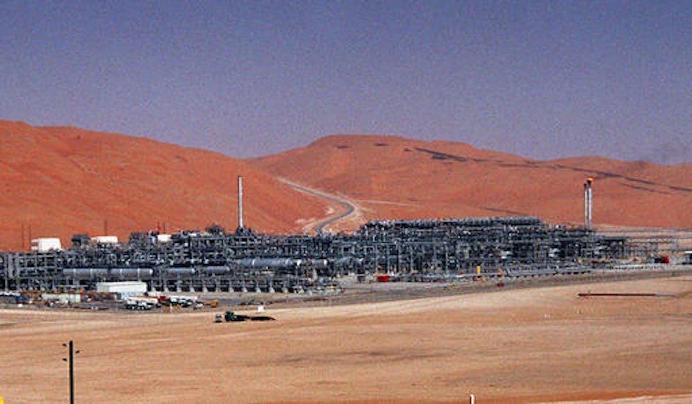 FILE - In this Monday, March 8, 2004 file photo, an industrial plant strips natural gas from freshly pumped crude oil is seen at Saudi Aramco's Shaybah oil field at Shaybah in Saudi Arabia's Rub al-Khali desert. King Salman announced the approval for the "Vision 2030" plan in a short televised announcement on Monday in which he called on Saudis to work together ensure its success. (AP Photo/Bruce Stanley, File)