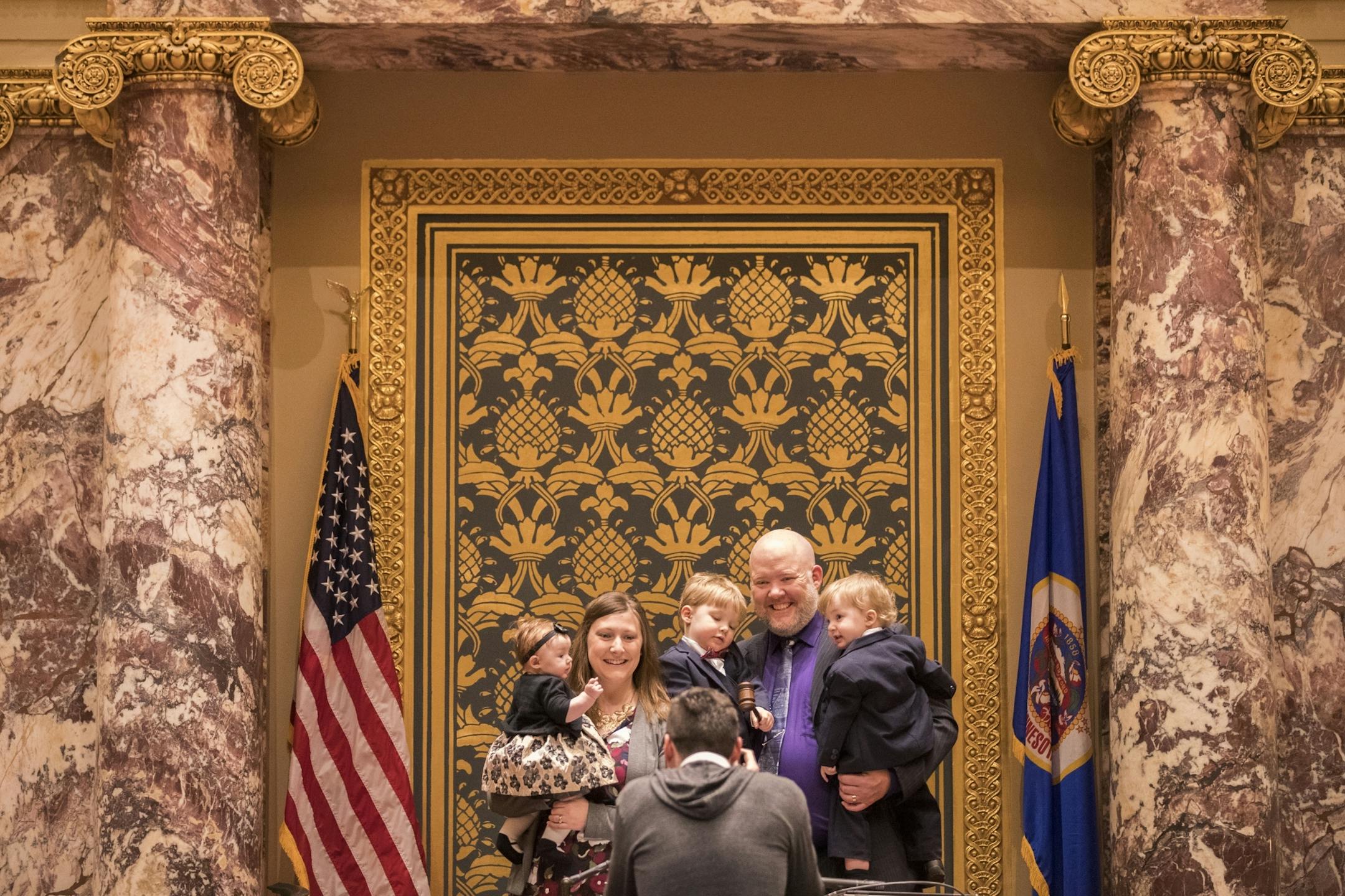 Senator-elect Jason Isaacson, right, with his wife Cynthia and children, from right, Owen, 1, Iver, 3, and four-month-old Esne, pose for a photo in the Senate Chambers before the start of the session.