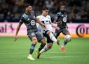 Vancouver Whitecaps' Brian White takes a shot on goal as Minnesota United's Michael Boxall defends