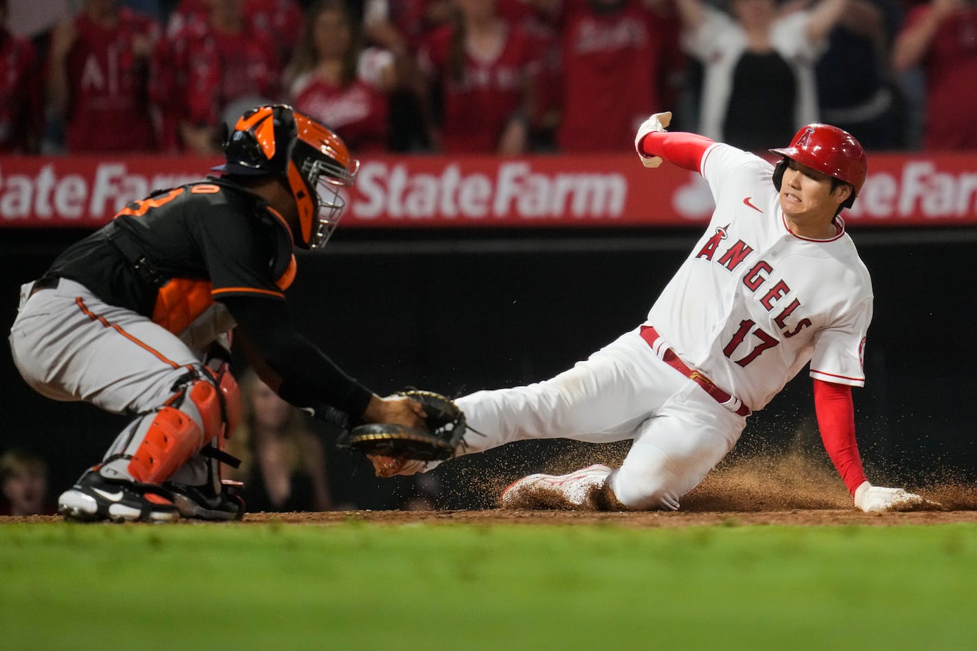 Los Angeles Angels designated hitter Shohei Ohtani (17) slides in to home to score ahead of a tag by Baltimore Orioles catcher Pedro Severino (28) during the ninth inning of a baseball game Friday, July 2, 2021, in Anaheim, Calif. The run won the game for the Angels 8-7. (AP Photo/Ashley Landis)