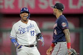 Kansas City Royals' Salvador Perez (13) celebrates on second after hitting an RBI double during the first inning of a baseball game against the Minnes