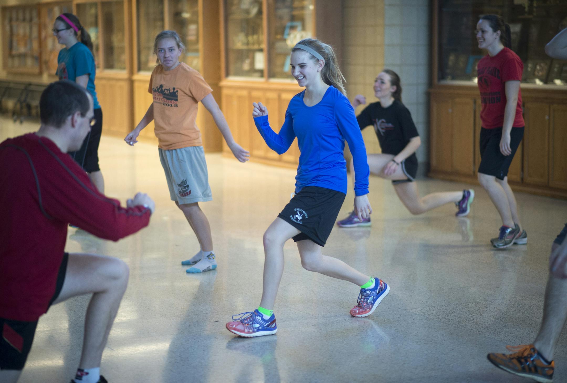 Belle Plaine senior distance runner Janessa Meuleners, center, stretches before her running workout during Tuesday's track practice. ] (Aaron Lavinsky | StarTribune) A Belle Plaine track practice is photographed Tuesday, March 10, 2015 at Belle Plaine High School.