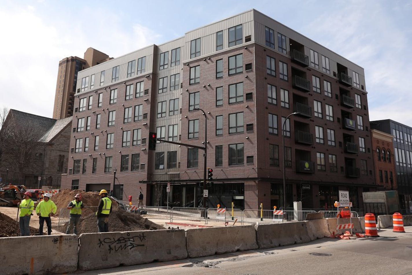 Construction workers dug up pipes outside the M on Hennepin apartments.