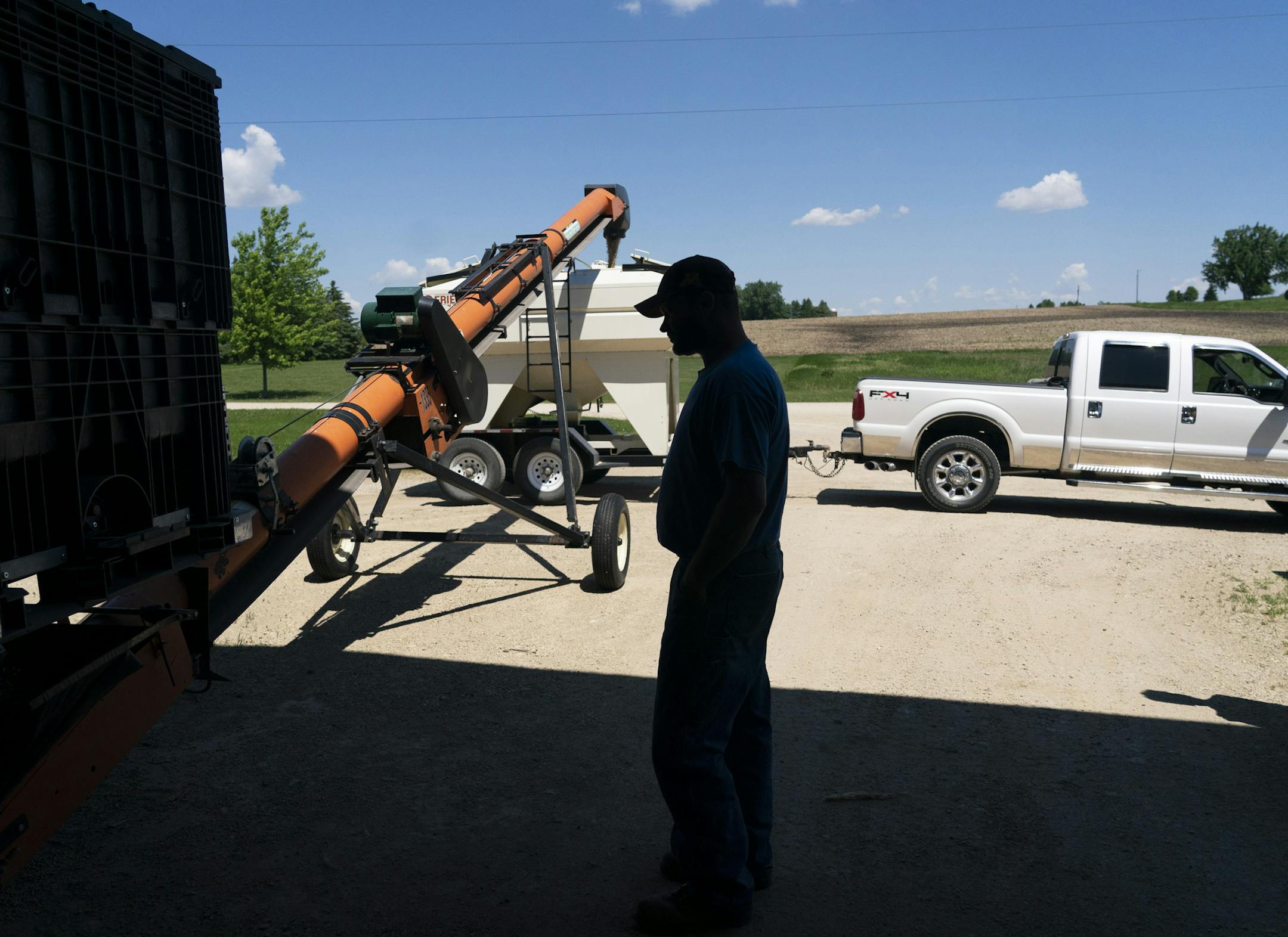 Brent Fuchs, a farmer and seed dealer in Dundas, Minn., filled soybean seed into a trailer owned by another farmer, Connie Cihak, last week. Cihak changed her seed order four times to account for the late planting season. ] RENEE JONES SCHNEIDER ¥ renee.jones@startribune.com