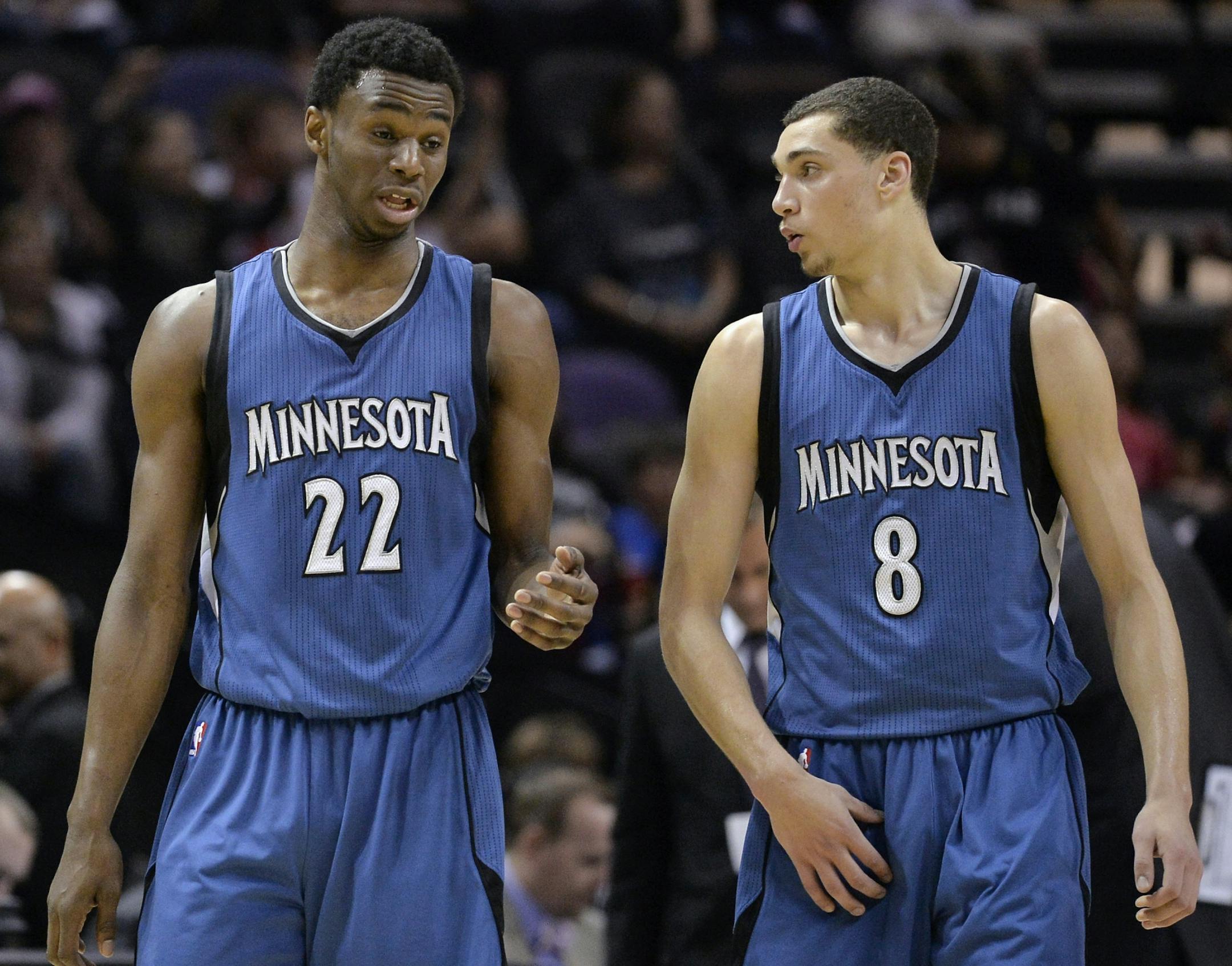 Timberwolves guards Andrew Wiggins, left, and Zach LaVine, speak during the second half of an NBA basketball game against the San Antonio Spurs, Sunday, March 15, 2015, in San Antonio. San Antonio won 123-97.