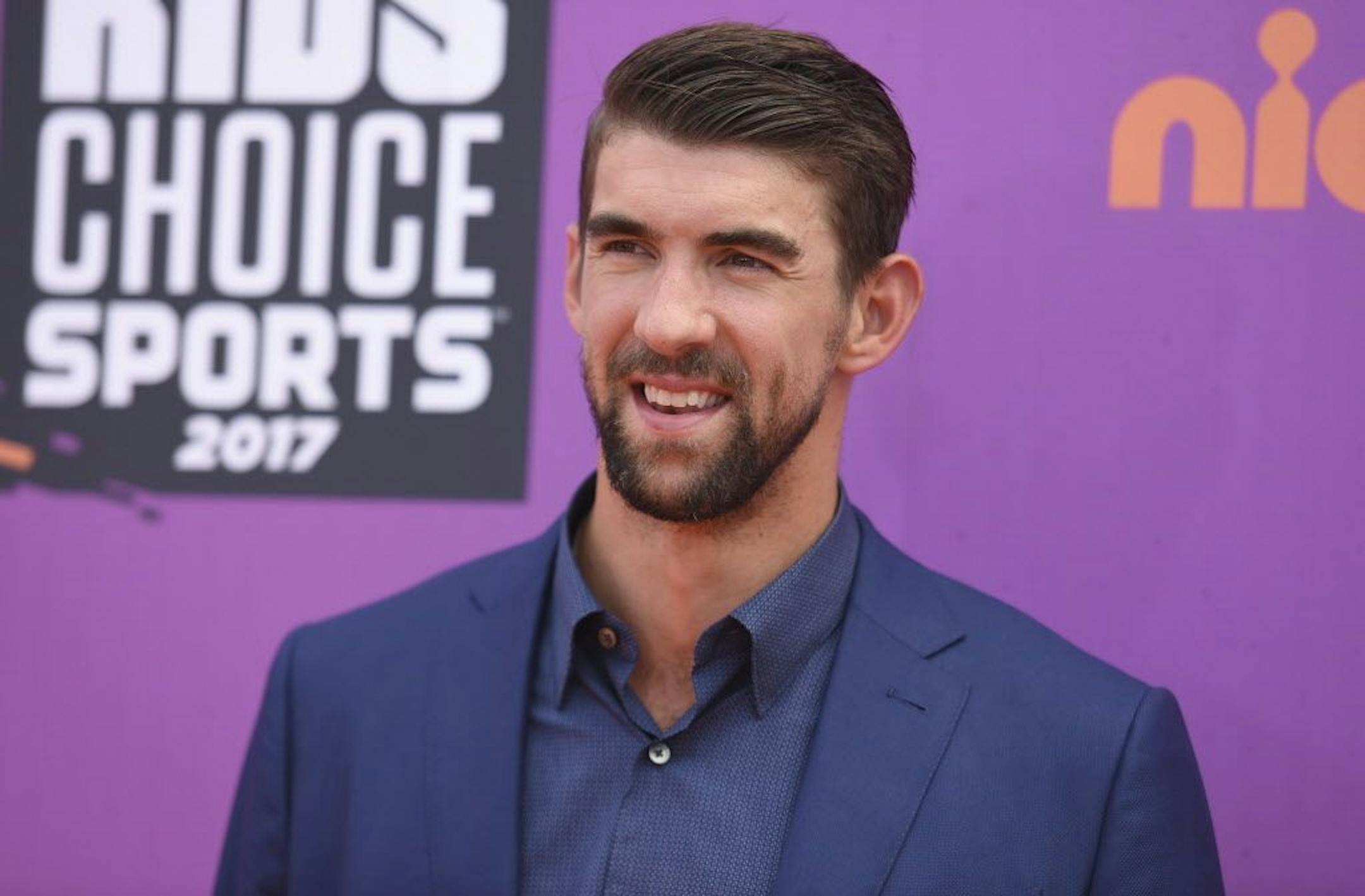 FILE - In this July 13, 2017 file photo, retired Olympic swimmer Michael Phelps arrives at the Kids' Choice Sports Awards at UCLA's Pauley Pavilion in Los Angeles. Phelps lost to a shark in the Discovery Channel�s Shark Week special �Phelps vs. Shark: Great Gold vs. Great White," which aired on July 23, 2017. It was billed as a race between Phelps and the predator but much to the disappointment of some Twitter users, Phelps didn�t actually swim in the water next to the shark.