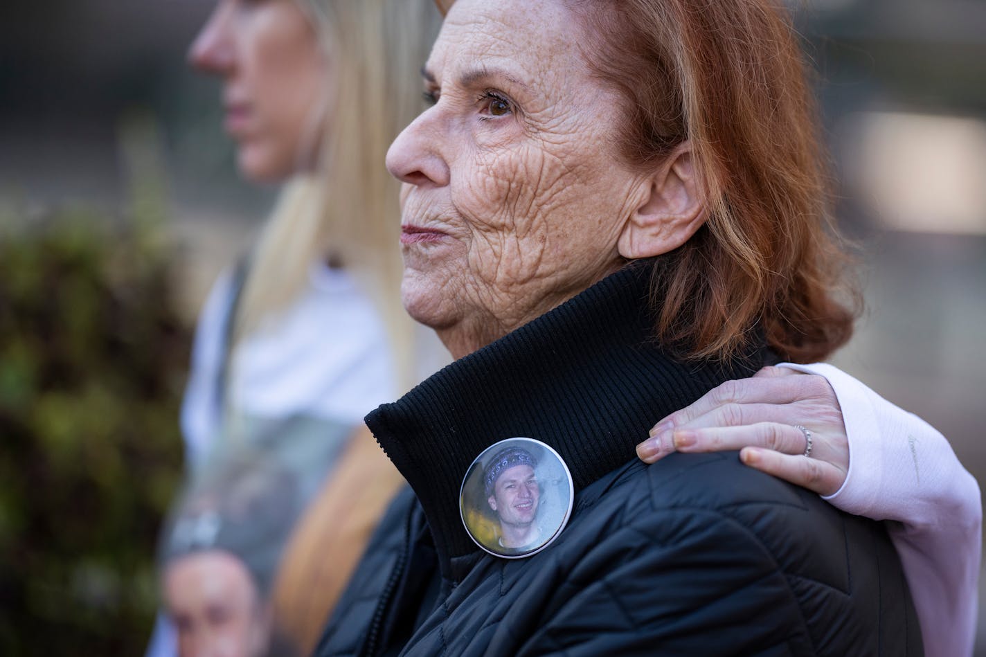 Catherine Markey wears a button with her son Stephen Markey's photo on it during a rally in protest of Hennepin County Attorney Mary Moriarty outside the Hennepin County Government Center.