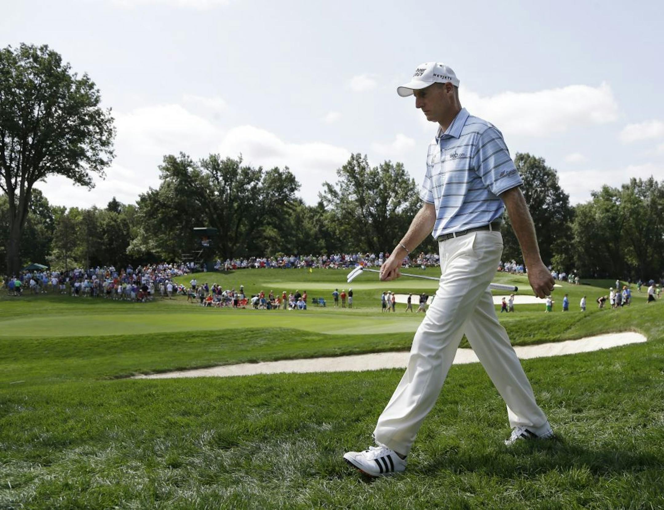 Jim Furyk walked off the fourth green during the first round of the PGA Championship golf tournament at Oak Hill Country Club on Thursday.