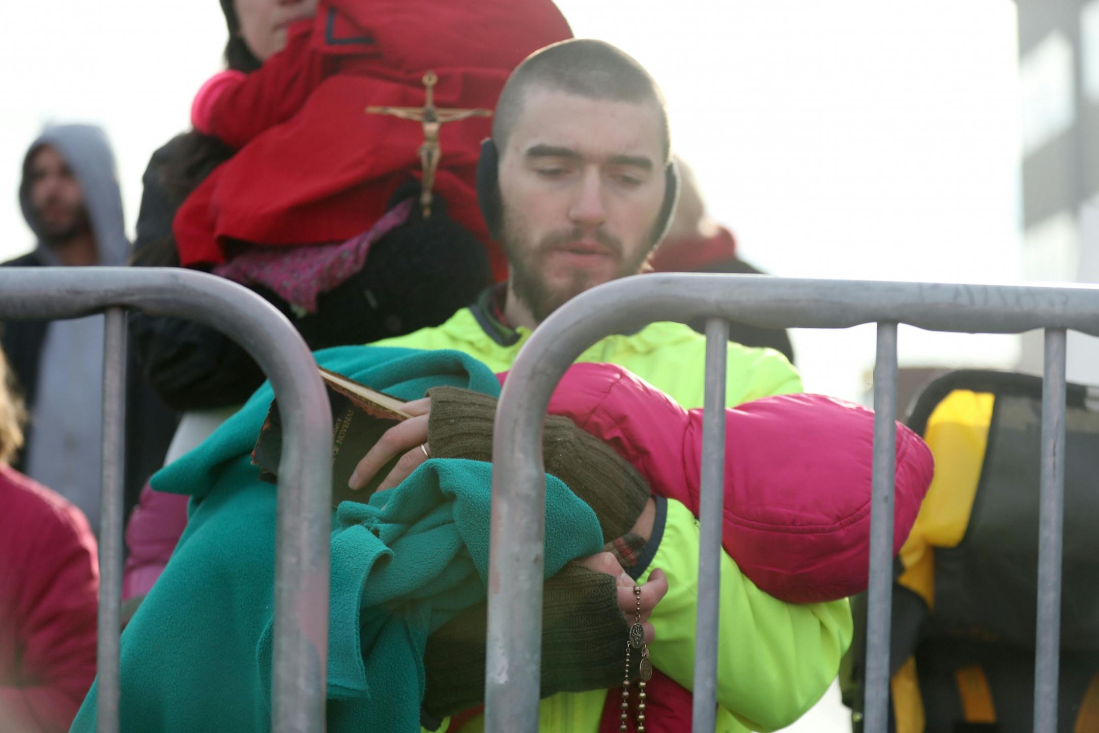 Samuel Willodson of White Bear Lake, a supporter of Pro-Life Action Ministries, kneeled with a child and a rosary as he prayed. Wilson and his wife Jacquelyn, who said she volunteered for Planned Parenthood in 2013 and saw how they operated before the family chose to convert to Catholicism, came to the event with their three children.