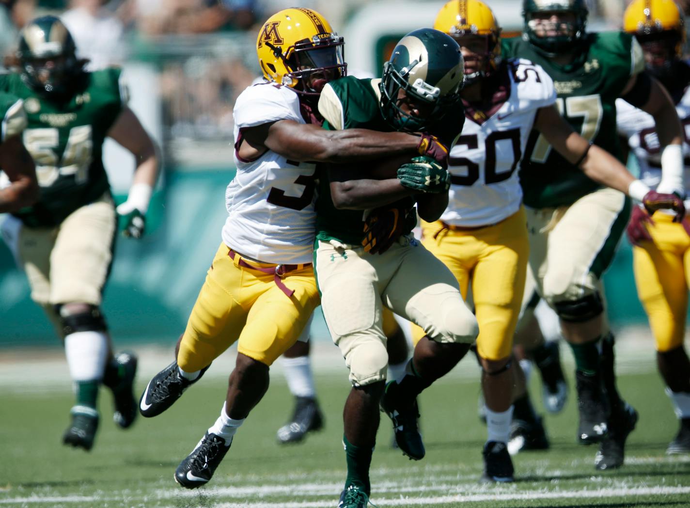 Minnesota defensive back Eric Murray, left, drags down Colorado State running back Dalyn Dawkins after a long gain the first quarter of an NCAA college football game Saturday, Sept. 12, 2015, in Fort Collins, Colo. (AP Photo/David Zalubowski)