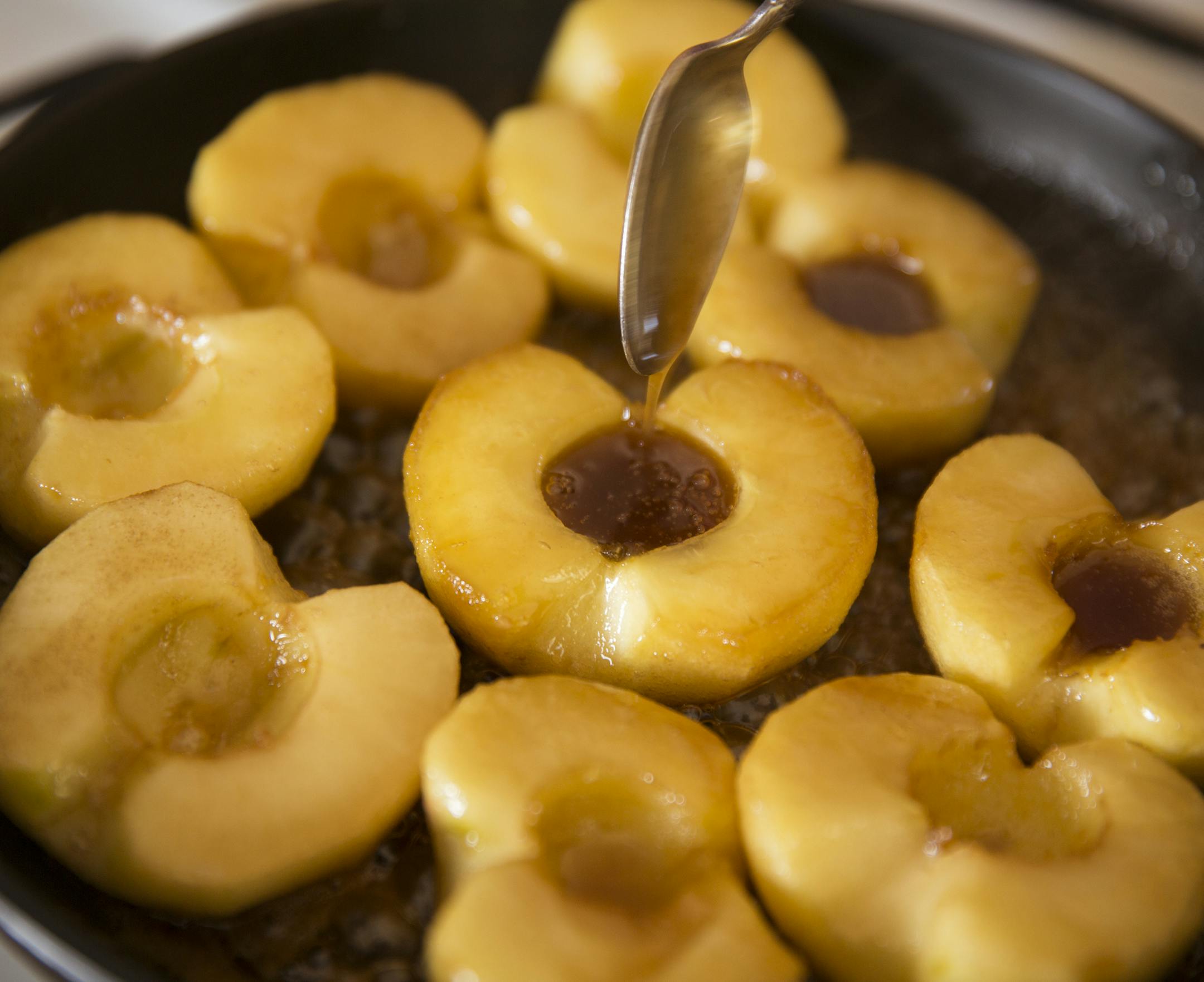 Flip the apples in the caramel. Baking Central makes Apple Tarte Tatin. ] (Leila Navidi/Star Tribune) leila.navidi@startribune.com BACKGROUND INFORMATION: Baking Central makes Tarte Tatin for apple season, with an easy, flaky pastry on Thursday, October 13, 2016.