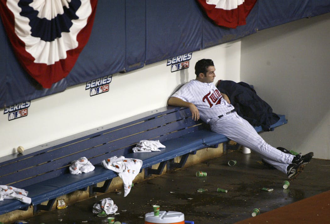 Twins pitcher Juan Rincon sat in the dugout after allowing the Yankees to tie the score in the eighth inning of Game 4 of the 2004 ALDS. New York went on to clinch the series with a 6-5 win.